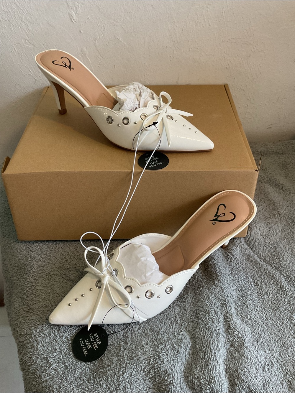 White Pointed-Toe Slip-On Heels with Bow and Grommet Detail